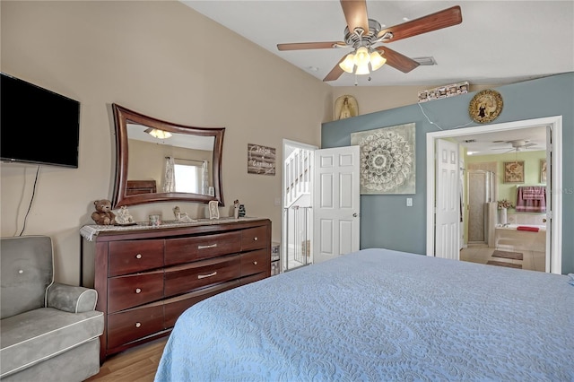 bedroom with lofted ceiling, ensuite bath, ceiling fan, and light hardwood / wood-style floors