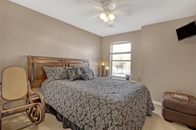 carpeted bedroom featuring a textured ceiling and ceiling fan