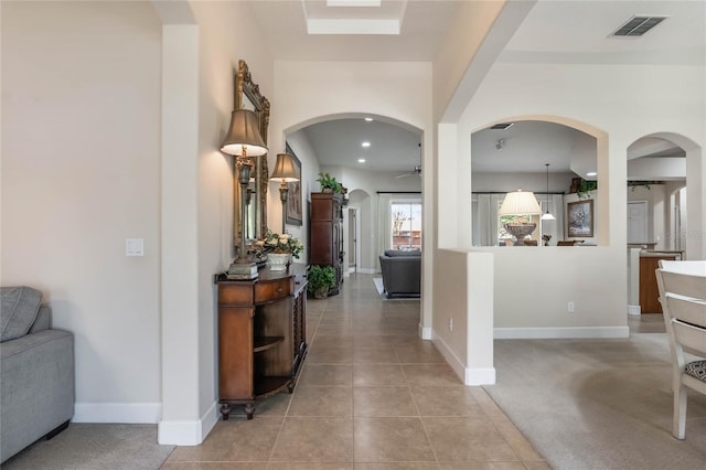 corridor featuring light tile patterned floors