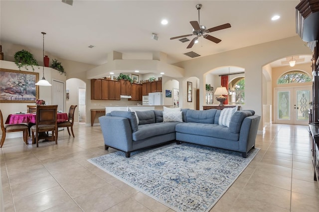 tiled living room featuring french doors and ceiling fan