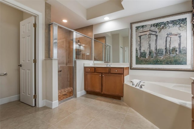 bathroom featuring shower with separate bathtub, vanity, and tile patterned floors