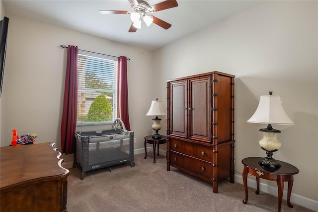 miscellaneous room with ceiling fan and light carpet