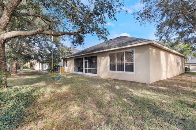 rear view of property with a yard