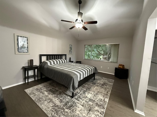 bedroom with ceiling fan, vaulted ceiling, and hardwood / wood-style flooring