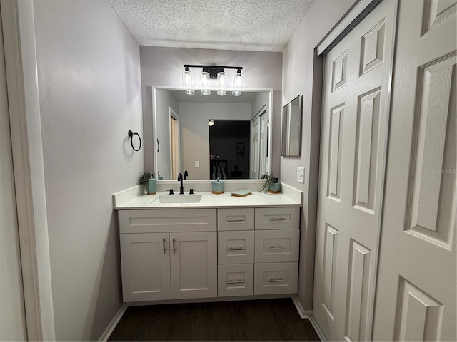 bathroom with a textured ceiling and vanity