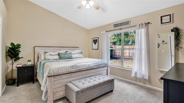 bedroom with light colored carpet, vaulted ceiling, and ceiling fan