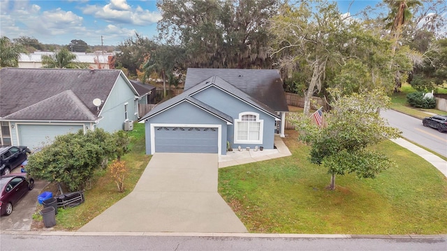 view of front of home with a garage and a front lawn