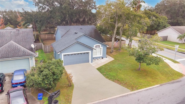 view of front of property with a front yard and a garage