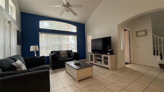 tiled living room with high vaulted ceiling and ceiling fan