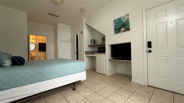 tiled bedroom with a textured ceiling