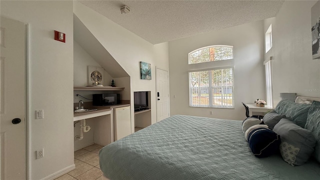 tiled bedroom featuring sink and a textured ceiling