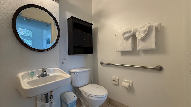 bathroom with tile patterned floors, toilet, and sink