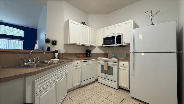 kitchen with decorative backsplash, white appliances, sink, light tile patterned floors, and white cabinetry