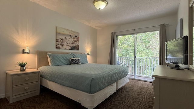 bedroom featuring dark colored carpet, a textured ceiling, and access to outside