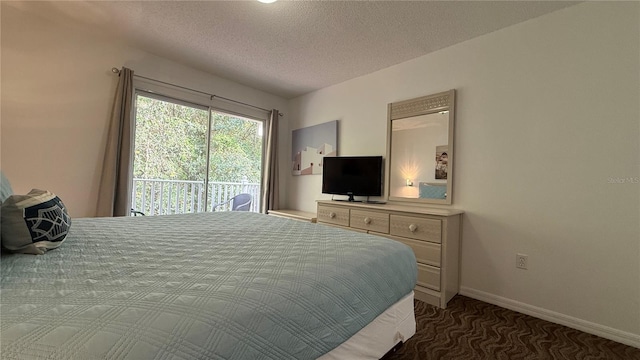 bedroom with access to outside and a textured ceiling