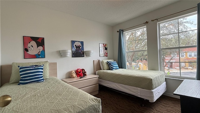 bedroom with multiple windows and a textured ceiling