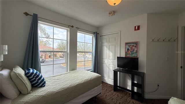 bedroom with a closet and a textured ceiling