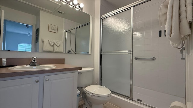 bathroom with vanity, an enclosed shower, and toilet