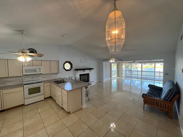 kitchen with kitchen peninsula, backsplash, white appliances, sink, and light tile patterned flooring