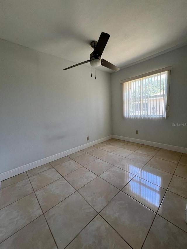 unfurnished room featuring ceiling fan and light tile patterned flooring