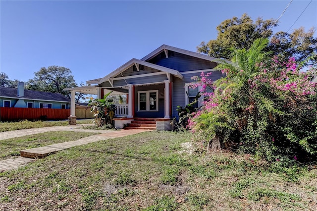 view of front of property with covered porch and a front lawn