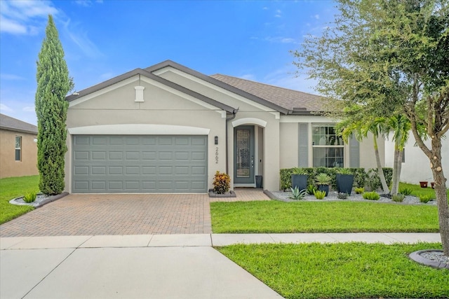 single story home featuring a garage and a front lawn