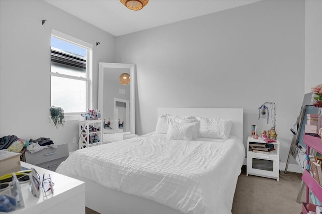 carpeted bedroom featuring multiple windows