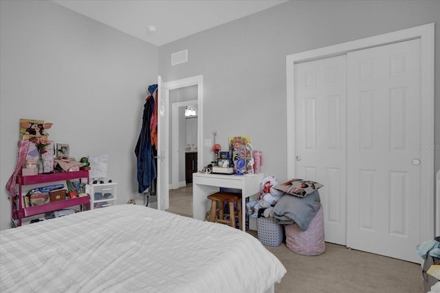 bedroom featuring light carpet and a closet