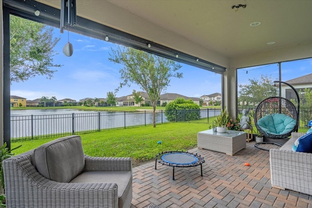 sunroom / solarium featuring a water view