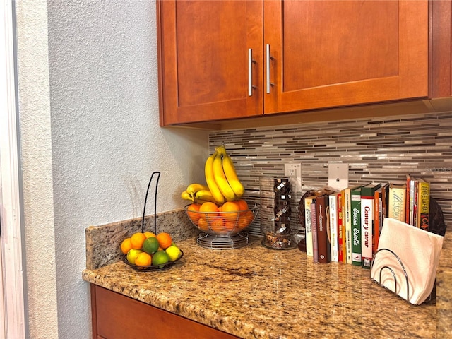 details featuring decorative backsplash and light stone countertops