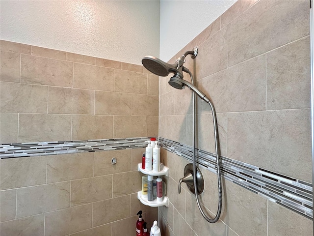 interior details featuring a tile shower