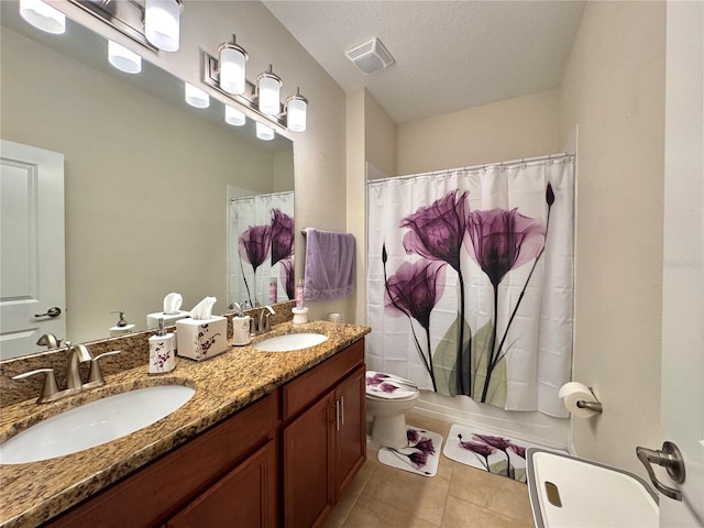 bathroom featuring toilet, vanity, tile patterned floors, a textured ceiling, and curtained shower