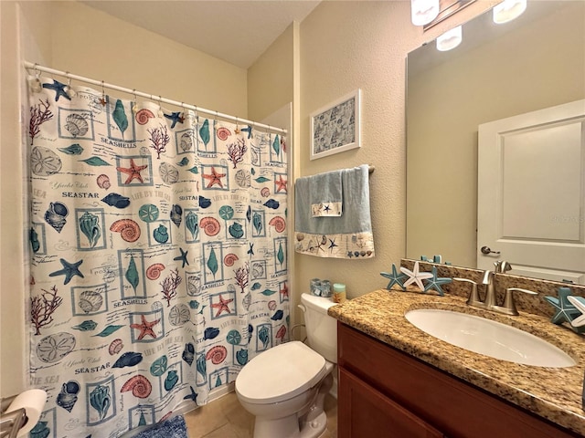 bathroom with toilet, vanity, a shower with curtain, and tile patterned flooring