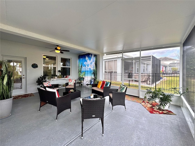 sunroom featuring ceiling fan