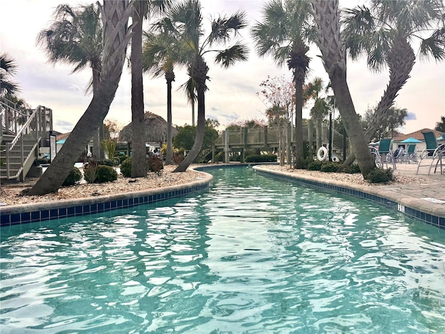 view of pool at dusk