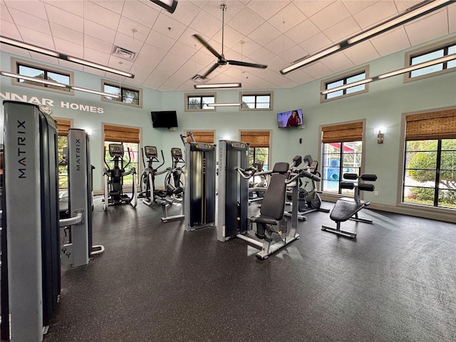 workout area featuring a towering ceiling