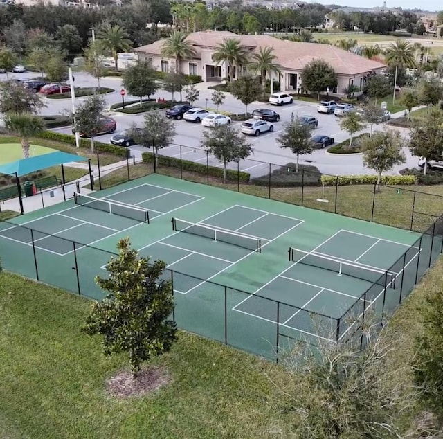 view of sport court with a lawn