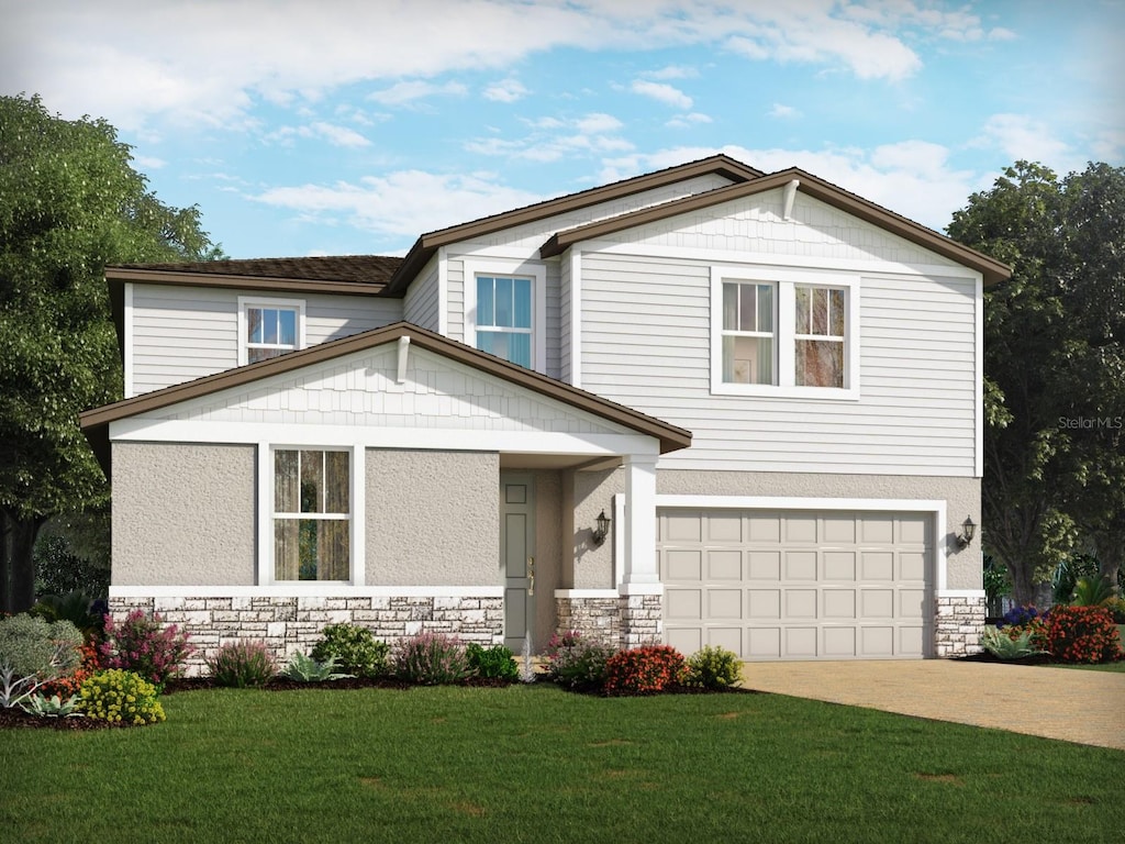 view of front facade with a garage and a front lawn