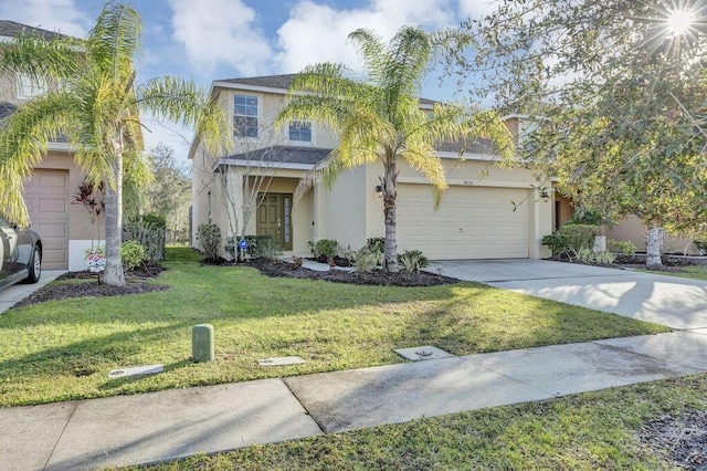 view of front of home with a front yard and a garage