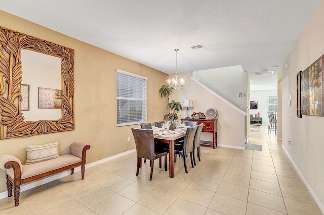 dining space featuring a chandelier and light tile patterned floors