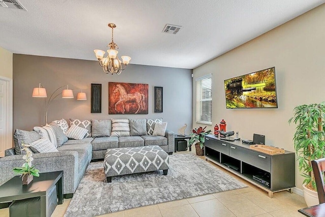 living room with a notable chandelier and light tile patterned flooring