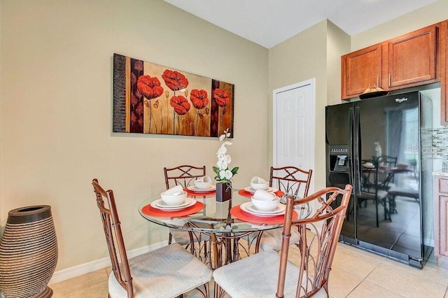 dining space featuring light tile patterned flooring