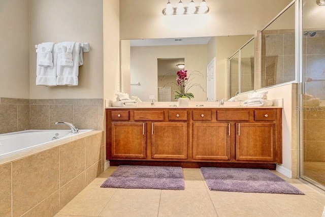 bathroom with tile patterned floors, vanity, and separate shower and tub