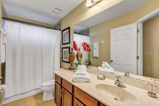 full bathroom featuring tile patterned floors, shower / bathtub combination with curtain, vanity, and toilet