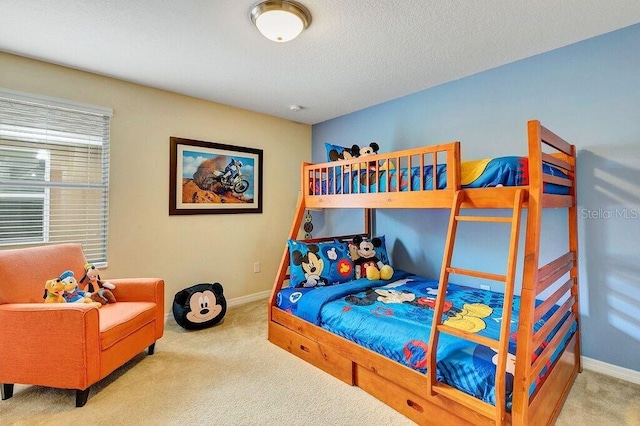 bedroom with carpet flooring and a textured ceiling