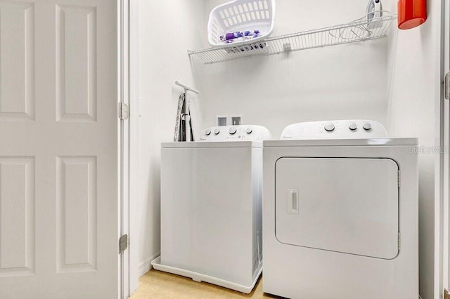 laundry area featuring washing machine and clothes dryer