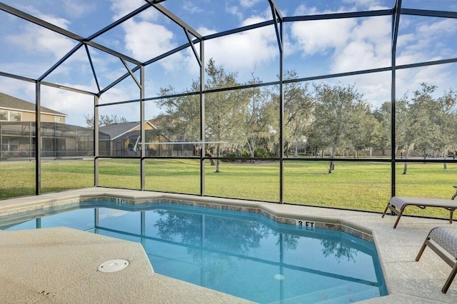 view of pool featuring a lawn, glass enclosure, and a patio area