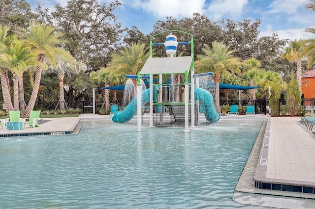 view of swimming pool featuring a playground