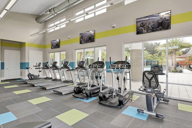 workout area with a high ceiling