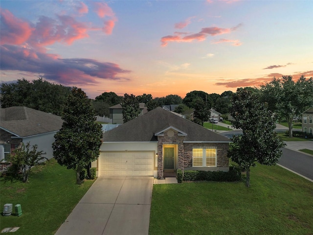 view of front facade featuring a lawn and a garage